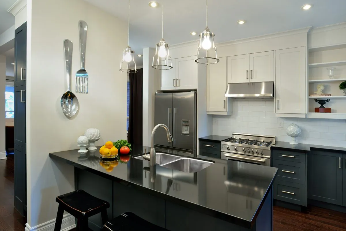 Steel grey lower cabinets in this kitchen co-ordinate well with the stainless steel appliances. (Larry Arnal)