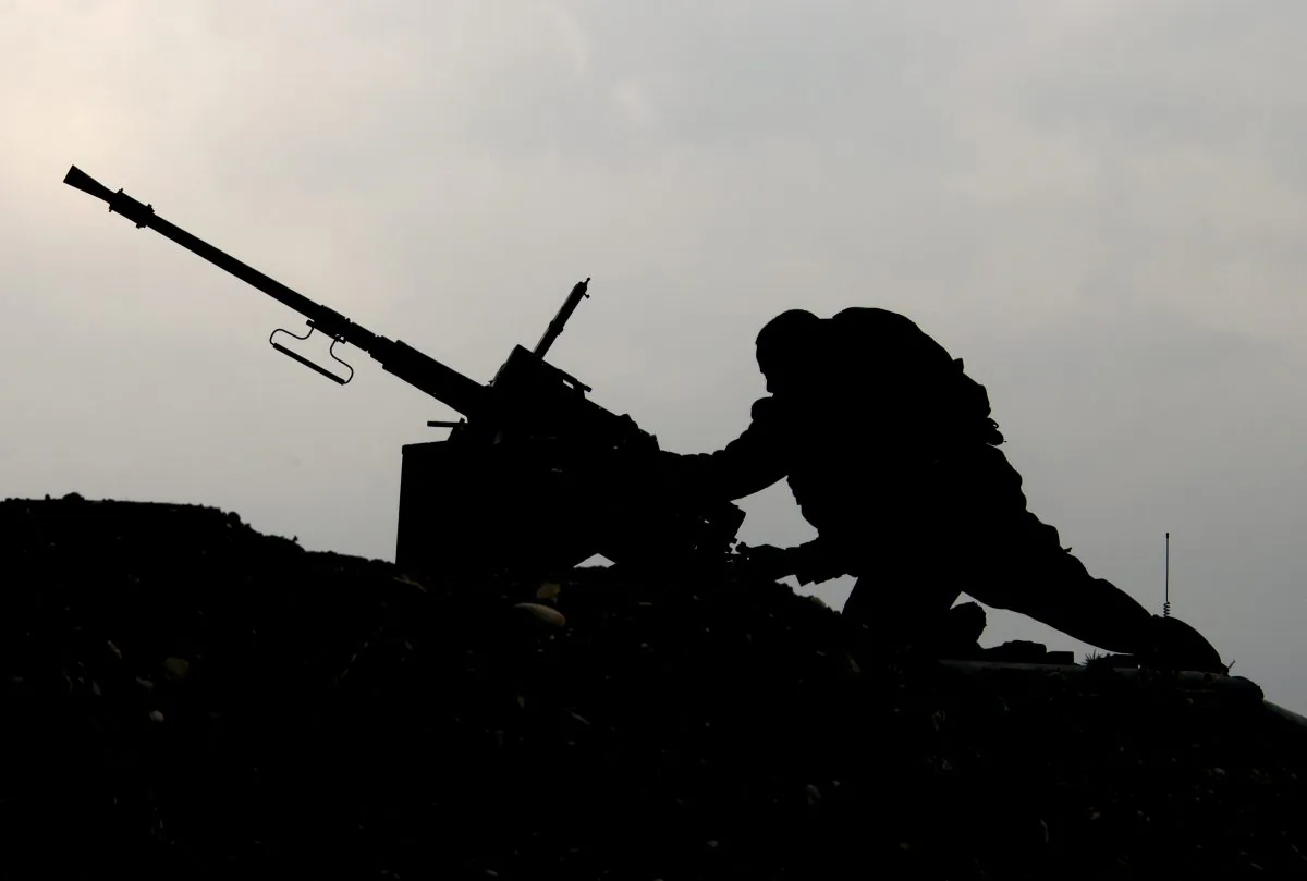 An Israeli soldier on an army vehicle stationed on the border between Israel and the Gaza Strip, on March 13, 2014. (Jack Guez/AFP/Getty Images)