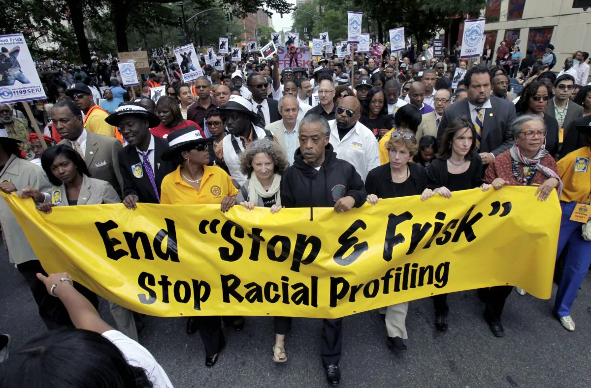 The Rev. Al Sharpton (C) walks with demonstrators during a silent march to end the stop-and-frisk program in New York, June 17, 2012. Mayor Bill de Blasio ended a court challenge Wednesday to a racial profiling law started under the previous administration. (Seth Wenig/AP)