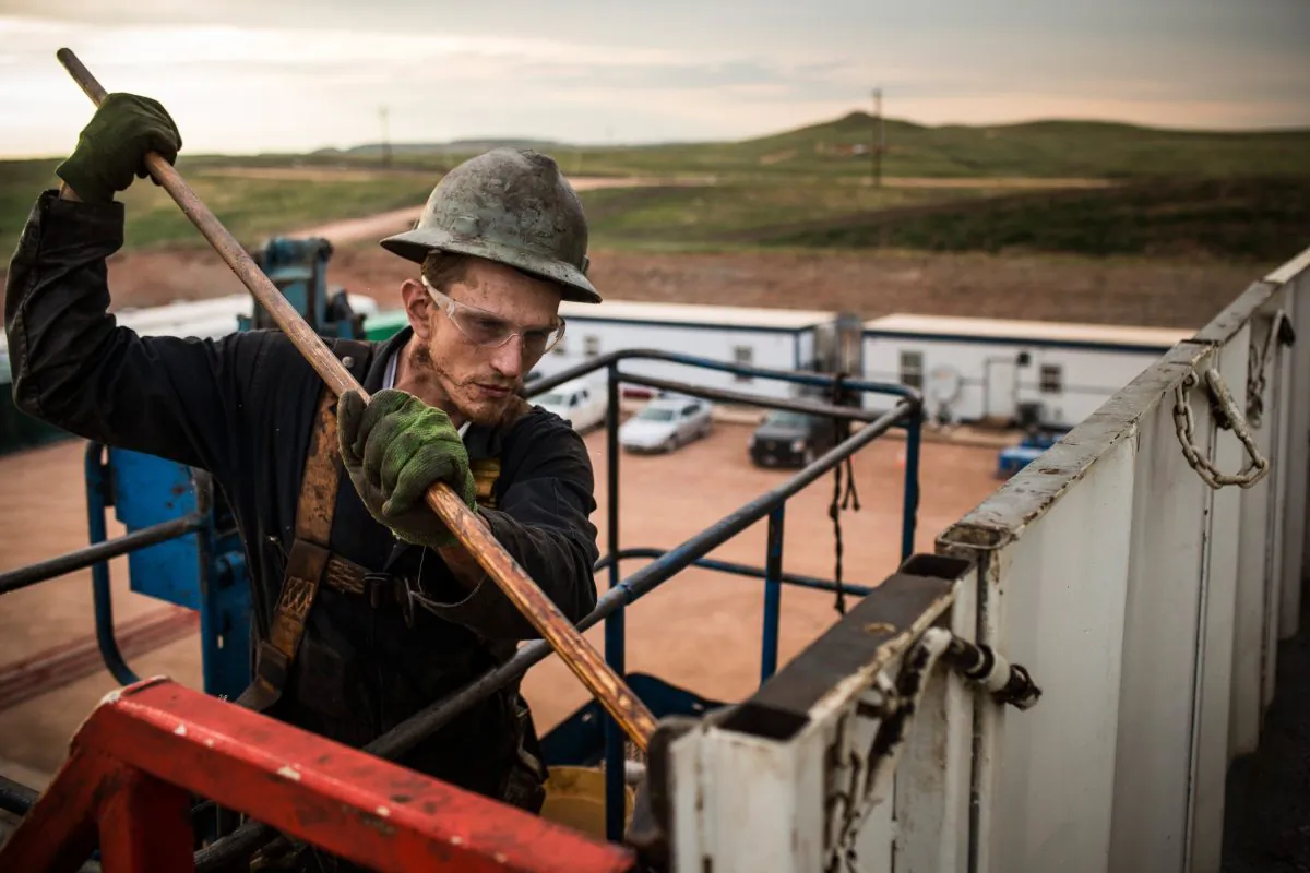 Ray Gerish, a floor hand for Raven Drilling, works on an oil rig drilling into the Bakken Shale formation outside Watford City, N.D., on July 28, 2013. In April 2013, the United States Geological Survey released a new study estimating the Bakken formation and surrounding oil fields could yield up to 7.4 billion barrels of oil, doubling their estimate of 2008. (Andrew Burton/Getty Images)