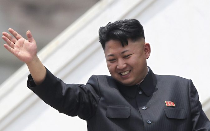 In this Saturday, July 27, 2013 photo, North Korean leader Kim Jong Un waves to war veterans during a mass military parade celebrating the 60th anniversary of the Korean War armistice in Pyongyang, North Korea. A Malaysian university faced public criticism Thursday for awarding an honorary doctorate in economics to North Korean leader Kim Jong Un, whose country is among the poorest in the world. (AP Photo/Wong Maye-E)