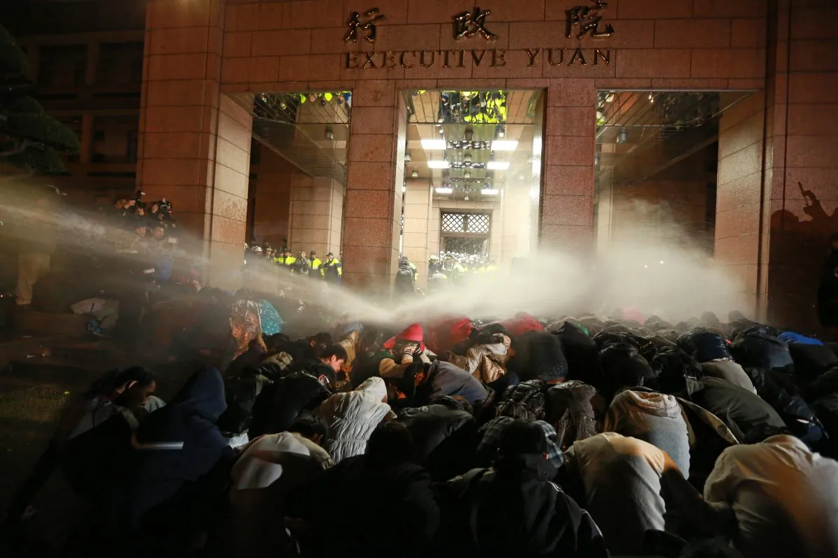 Protesters are sprayed by a water cannon during a demonstration outside the Executive Yuan in Taipei early on March 24. The protests followed Taiwan President Ma Ying-jeou's refusal to scrap a contentious trade agreement with China. (STR/AFP/Getty Images)