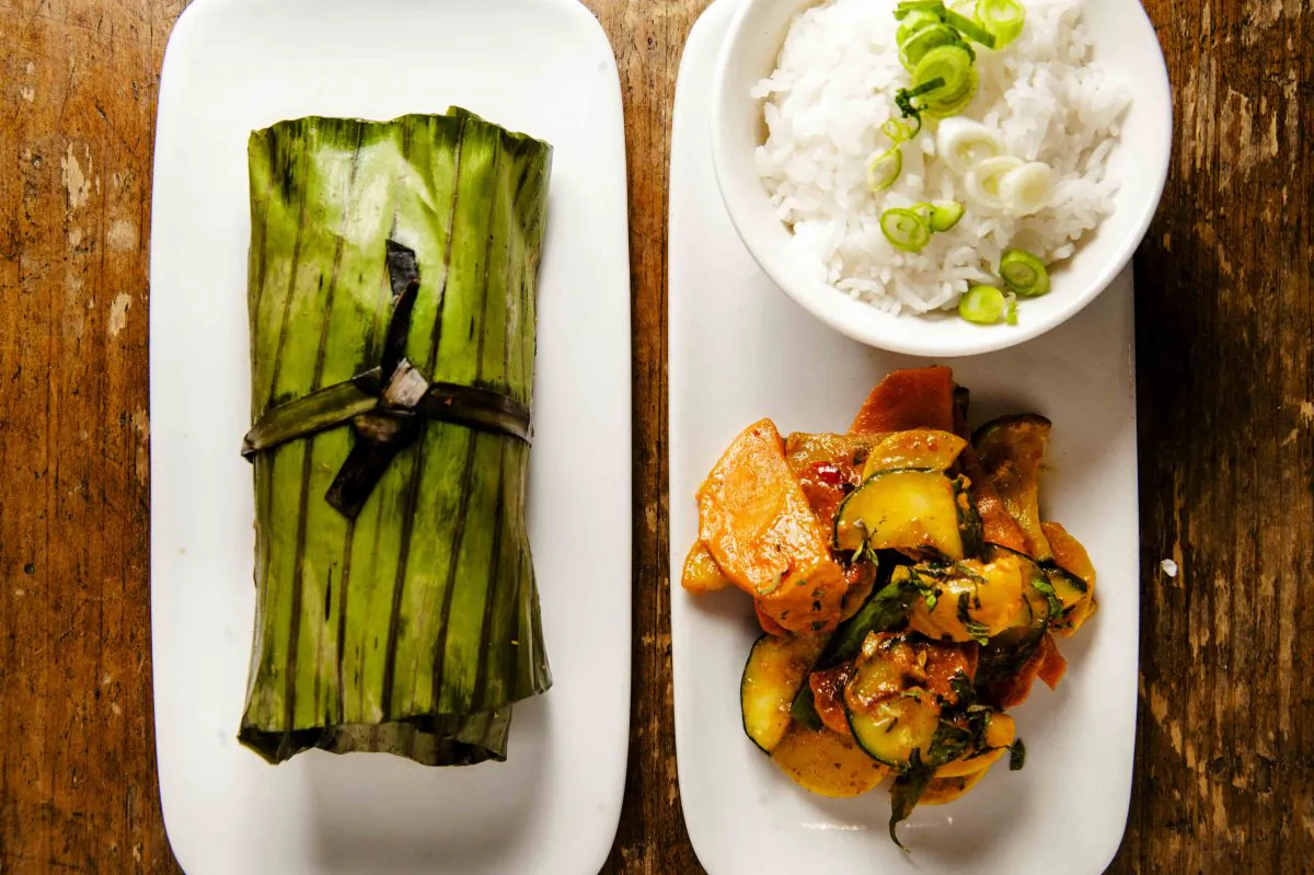 Pumpkin stuffed tilapia in banana leaf, coconut, and red curry vegetables. (Courtesy of Rodin Banica)