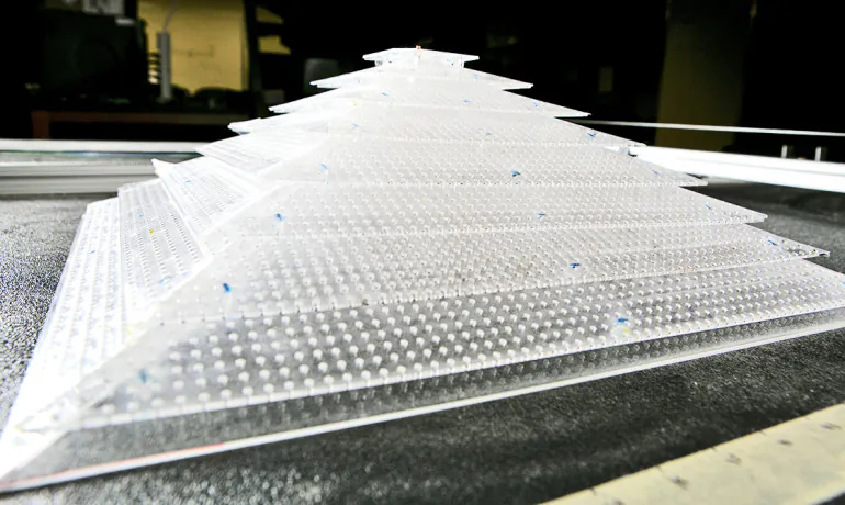 A close-up view of the 3D acoustic cloak. The geometry of the plastic sheets and placement of the holes interacts with sound waves to make it appear as if it isn't there. (Credit: Duke University) 