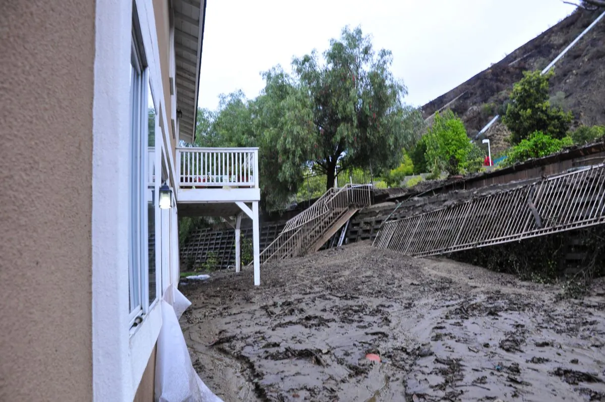  A backyard mudslide buried a recreation area and mud nearly filled to the rear window sills. (Robin Kemker/Epoch Times)