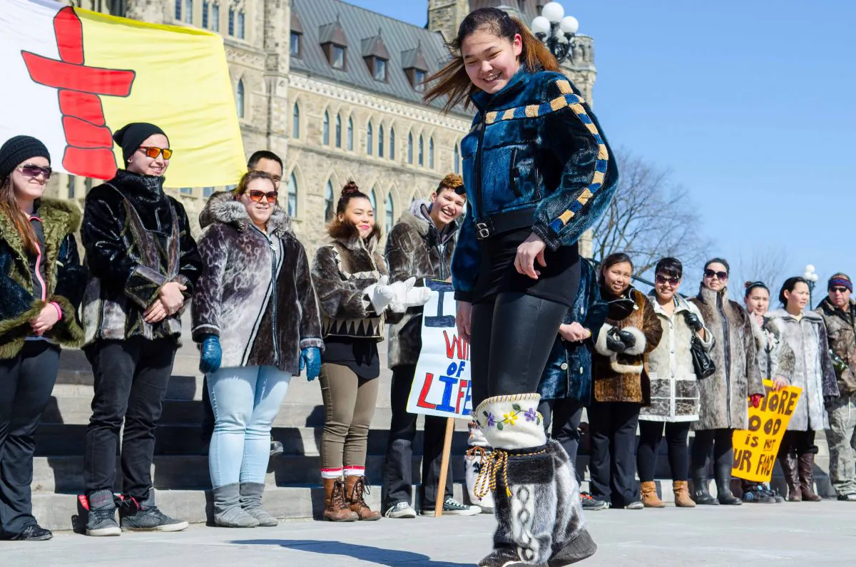 An Inuit student from Nunavut shows off a seal skin jacket and boots during a fashion show/protest on Parliament Hill, March 18, 2014. (Matthew Little/Epoch Times)
