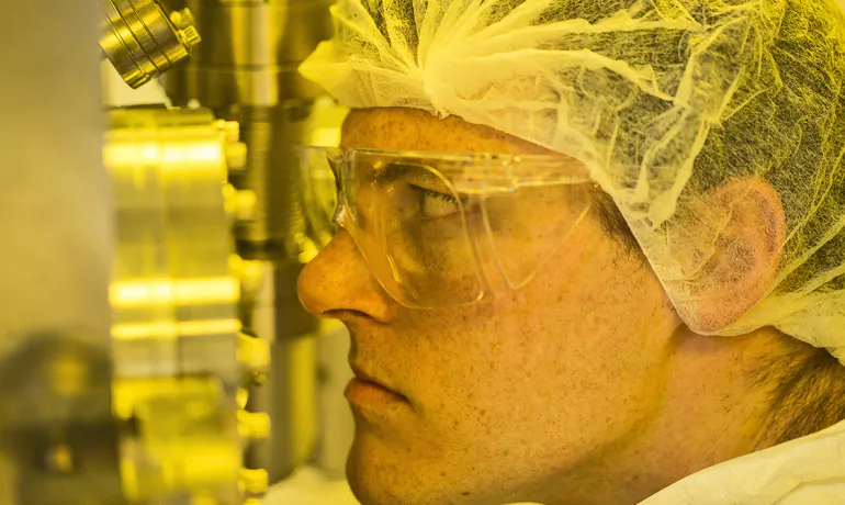 Student working at vapor deposition machine where the switches are made.. Photo by Joe Howell/Vanderbilt