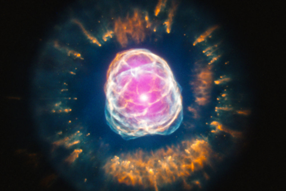 Stars like the Sun can become remarkably photogenic at the end of their life. A good example is NGC 2392, which is located about 4,200 light years from Earth. NGC 2392, (nicknamed the "Eskimo Nebula") is what astronomers call a planetary nebula. This designation, however, is deceiving because planetary nebulas actually have nothing to do with planets. The term is simply a historic relic since these objects looked like planetary disks to astronomers in earlier times looking through small optical telescopes. (X-ray: NASA/CXC/IAA-CSIC/N.Ruiz et al, Optical: NASA/STScI) 