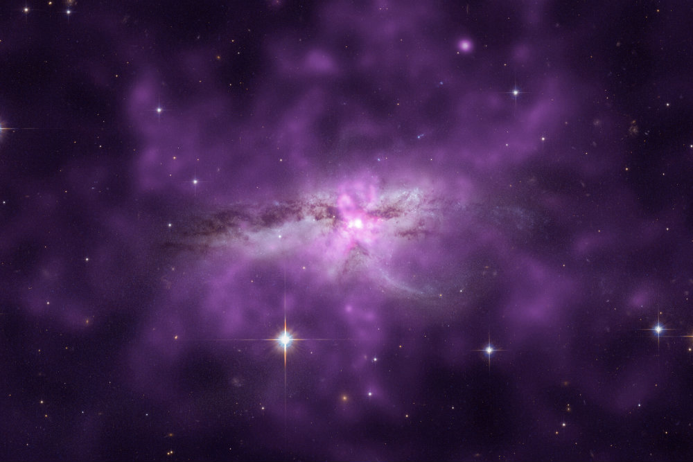 An enormous cloud of hot gas enveloping two large, colliding galaxies. This unusually large reservoir of gas contains as much mass as 10 billion Suns, spans about 300,000 light years, and radiates at a temperature of more than 7 million degrees Kelvin. (X-ray: NASA/CXC/SAO/E.Nardini et al; Optical: NASA/STScI) 