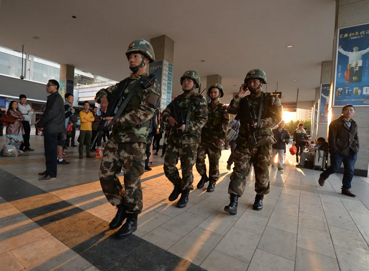 Chinese paramilitary police patrol outside the scene of the terror attack at the main train station in Kunming, Yunnan Province, on March 3, 2014. Discrimination against Uyghurs subsequent to the attack brought a response from some members of the Chinese public. (Mark Ralston/AFP/Getty Images)