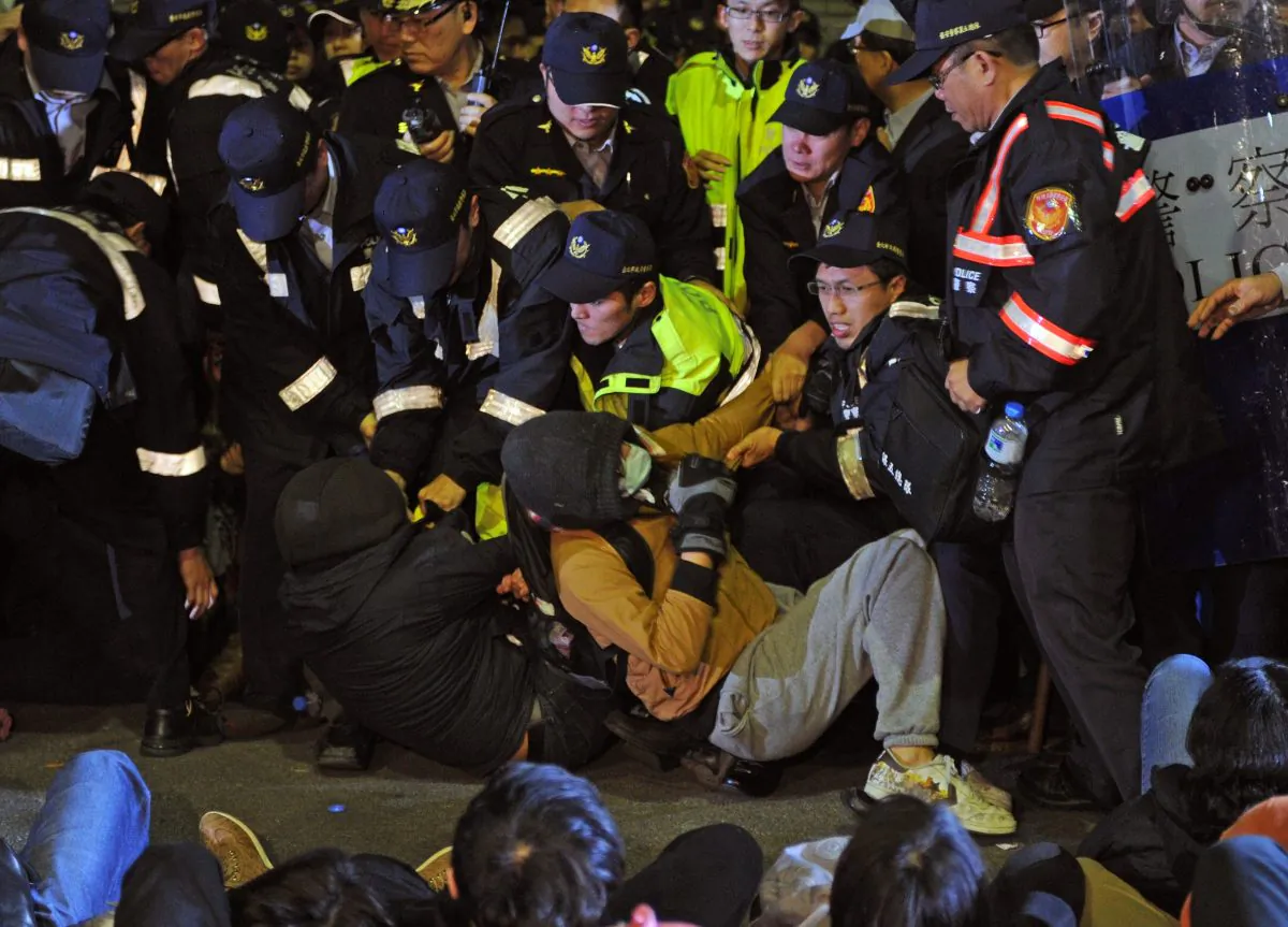 Police remove students from the ground at the Executive Yuan in Taipei on early March 24, 2014. Clashes between the police and students injured dozens of students. (SAM YEH/AFP/Getty Images)