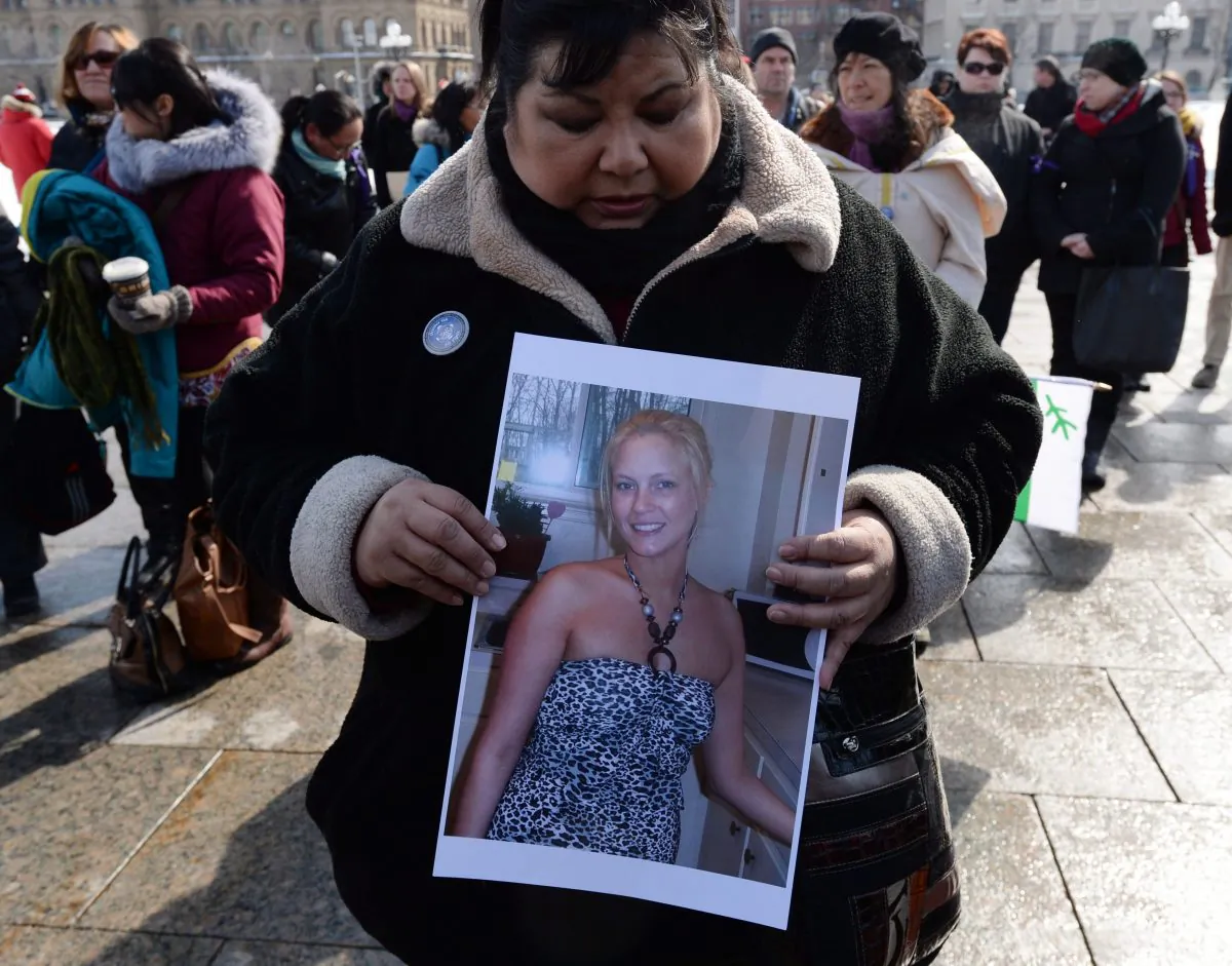 Ottawa resident Sharon Armstrong takes part in a vigil on Parliament Hill on Wednesday, March 5, 2014, for murdered Inuit student Loretta Saunders. Speakers at the vigil called for a national inquiry into missing and murdered aboriginal women. (The Canadian Press/Sean Kilpatrick)