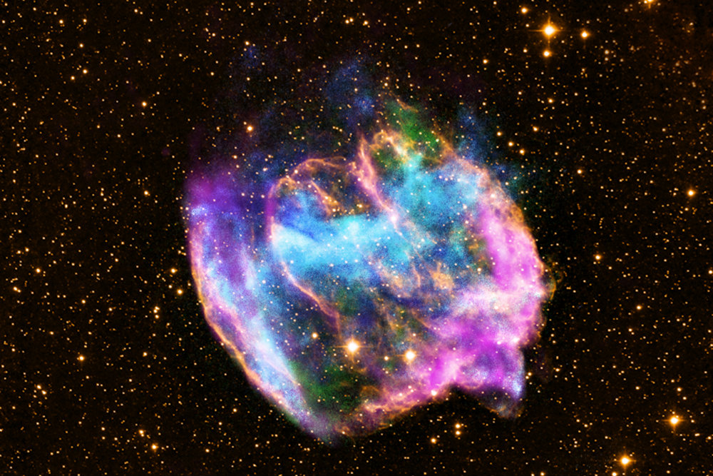 The highly distorted supernova remnant shown in this image may contain the most recent black hole formed in the Milky Way galaxy. The image combines X-rays from NASA's Chandra X-ray Observatory in blue and green, radio data from the NSF's Very Large Array in pink, and infrared data from Caltech's Palomar Observatory in yellow. The remnant, called W49B, is about a thousand years old, as seen from Earth, and is at a distance of about 26,000 light years away. (X-ray: NASA/CXC/MIT/L.Lopez et al.; Infrared: Palomar; Radio: NSF/NRAO/VLA) 