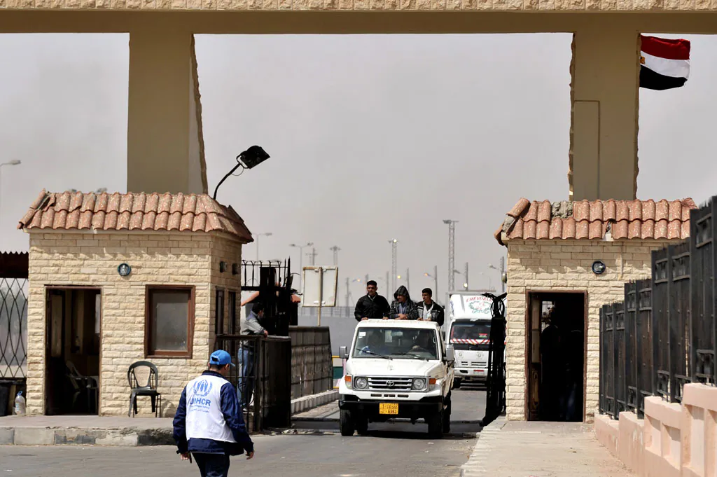 Evacuees from Libya cross the border with Egypt near the town of Sallum on March 17, 2011 as Libyan television said that forces loyal to Kadhafi had wrested control of Misrata, one of the last rebel-held bastion, and were 'purging' it of insurgents. (Aris Messinis/AFP/Getty Images)