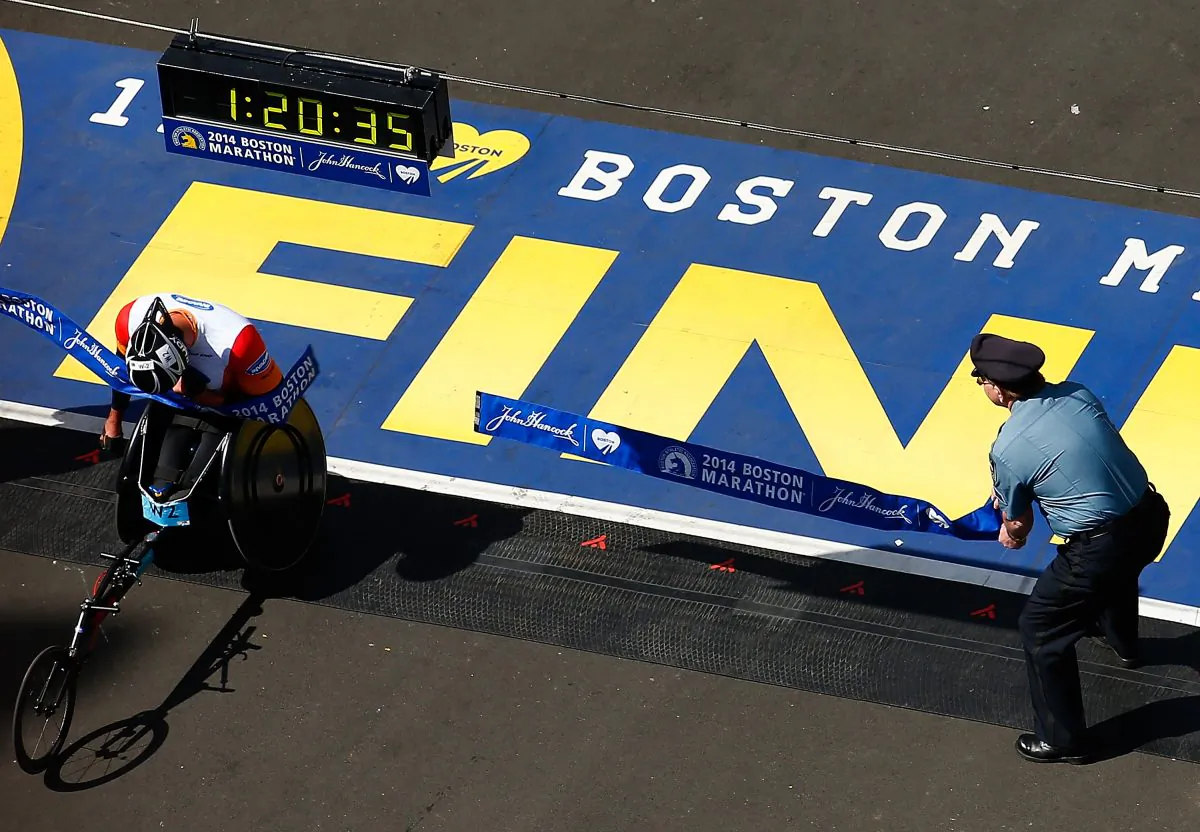 Ernst F. Van Dyk of South Africa crosses the finish line in first place in the men's wheelchair race during the 2014 B.A.A. Boston Marathon on April 21, 2014 in Boston, Massachusetts.(Jared Wickerham/Getty Images)