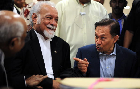 Malaysian opposition leader Anwar Ibrahim (R) discusses with his lawyers Sankaran Nair (L) and Karpal Singh (C) at a cafeteria in Kuala Lumpur on August 9, 2010 during a break on his ongoing sodomy trial. Anwar, a former deputy premier who was sacked and jailed on separate sex and corruption counts a decade ago, is accused of having illicit sexual relations with 25-year-old Mohamad Saiful Bukhari Azlan, who was an aide in his office.  AFP PHOTO / Saeed KHAN (Photo credit should read SAEED KHAN/AFP/Getty Images)