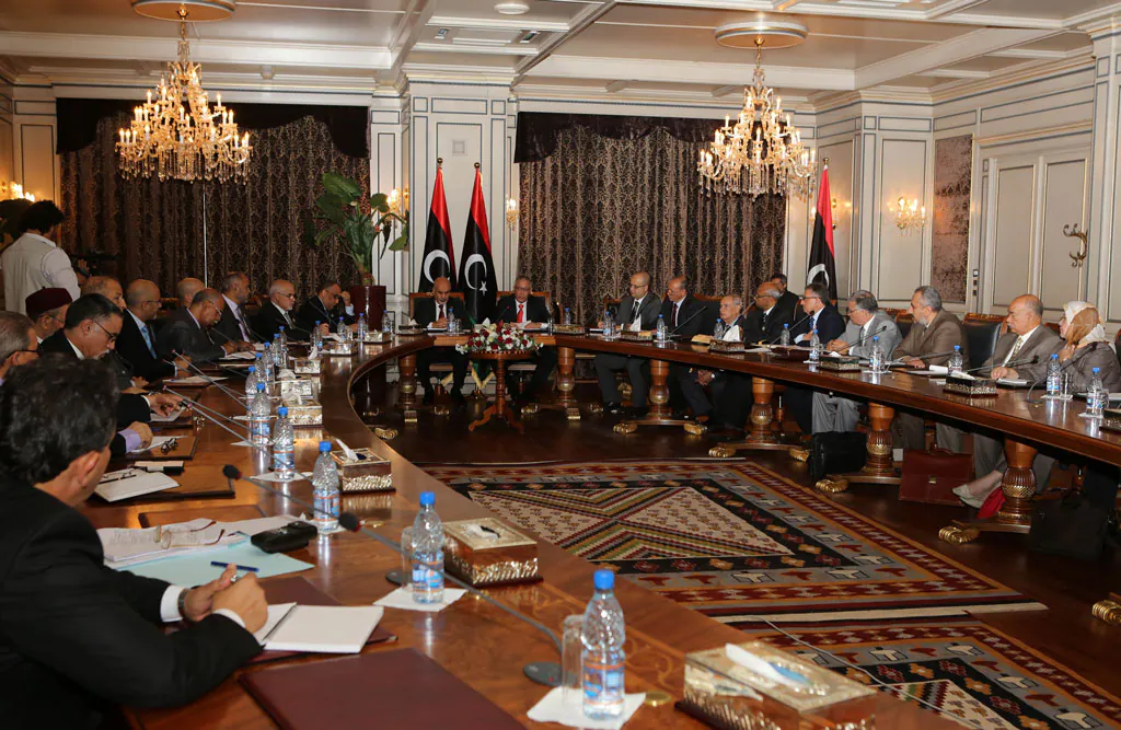 President of the General National Congress of Libya, Mohammed Megaryef (C-L), and newly elected Libyan Prime Minister Ali Zeidan (C-R) attend the first cabinet meeting of the newly formed Libyan government on November 21, 2012 in Tripoli. Zeidan's new cabinet was sworn in on November 14 and saw the appointment of 23 of Zeidan's 31 nominated ministers, who were approved by the GNC in October. (Mahmud Turkia/AFP/Getty Images)
