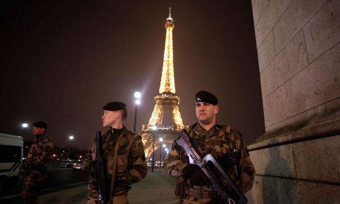 French soldiers stand guard near the Eiffel Tower in Paris on March 30, 2013. (Thomas Coex/AFP/Getty Images)