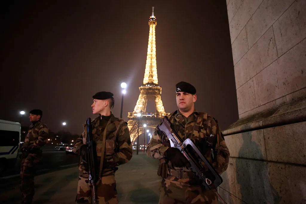 French soldiers stand guard near the Eiffel Tower in Paris on March 30, 2013. (Thomas Coex/AFP/Getty Images)