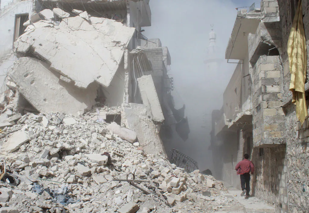 A Syrian man (R) runs past rubble as smoke billows in the background following a reported air strike by Syrian government forces on March 7, 2014 during the Friday prayers in the Sukkari neighborhood of the northern city of Aleppo. More than 140,000 people have been killed in Syria since the start of a March 2011 uprising against the Assad family's 40-year rule. (Baraa Al-Halabi/AFP/Getty Images)