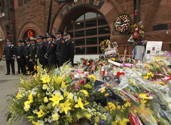BOSTON - APRIL 2: People pay their respects to the two fallen firefighters who lost their lives battling a nine alarm fire last week on April 2, 2014. (Photo by Essdras M Suarez/The Boston Globe via Getty Images)