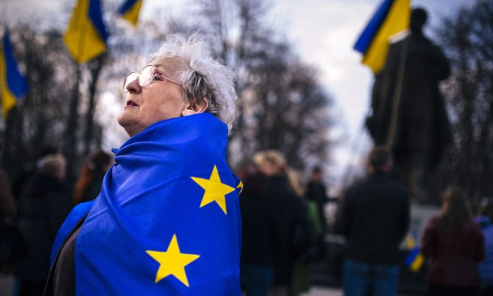 An elderly woman wrapped with an European Union flag attends a pro-Ukraine rally in the eastern Ukrainian city of Lugansk on April 15, 2014. Russia's foreign minister on April 15 warned Kyiv against using force to quell pro-Moscow separatists in eastern Ukraine, saying the "criminal" act would undermine talks planned in Geneva. Ukraine's Western-backed leader on April 15 accused Russia of trying to enflame the country's southeast but said he would proceed cautiously against pro-Kremlin militias consolidating control in the volatile region. (Dimitar Dilkoff/AFP/Getty Images)