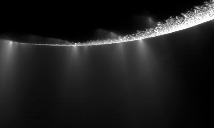 This photo provided by NASA shows water vapor jets, emitted from the southern polar region of Saturn's moon Enceladus. Scientists have uncovered a vast ocean beneath the icy surface of the moon, they announced Thursday, April 3, 2014. Italian and American researchers made the discovery using Cassini, a NASA-European spacecraft still exploring Saturn and its rings 17 years after its launch from Cape Canaveral. (AP Photo/NASA, JPL, Caltec, Space Science Institute)