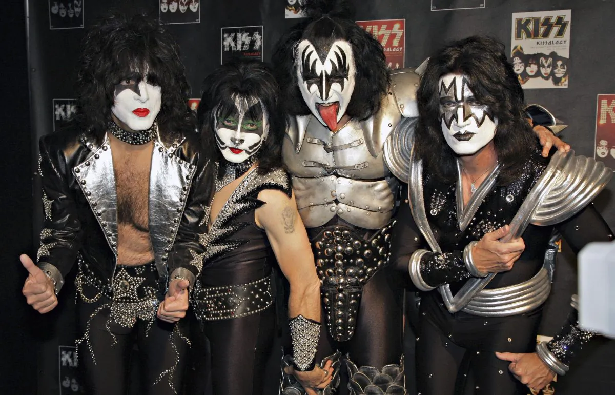 FILE - In this May 8, 2008 file photo, members of Kiss, from left, Paul Stanley, Eric Singer, Gene Simmons and Tommy Thayer, poses for a photograph during a news conference to promote the start of their KISS Alive/35 European Tour in Oberhausen, Germany. (AP Photo/Volker Wiciok, file)