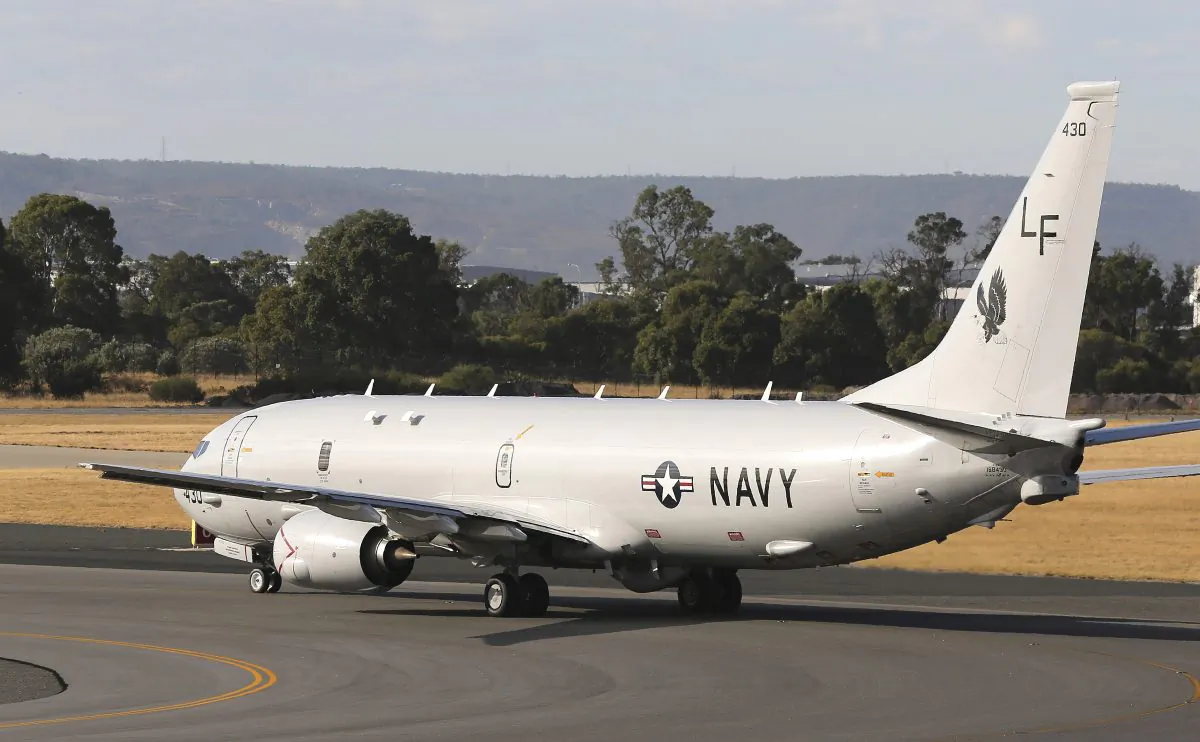 A U.S. Navy plane P-8 Poseidon takes off from Perth Airport on route to conduct search operations for missing Malaysia Airlines Flight MH370 in southern Indian Ocean, near the coast of Western Australia, Saturday, April 5, 2014. (AP Photo/Rob Griffith)