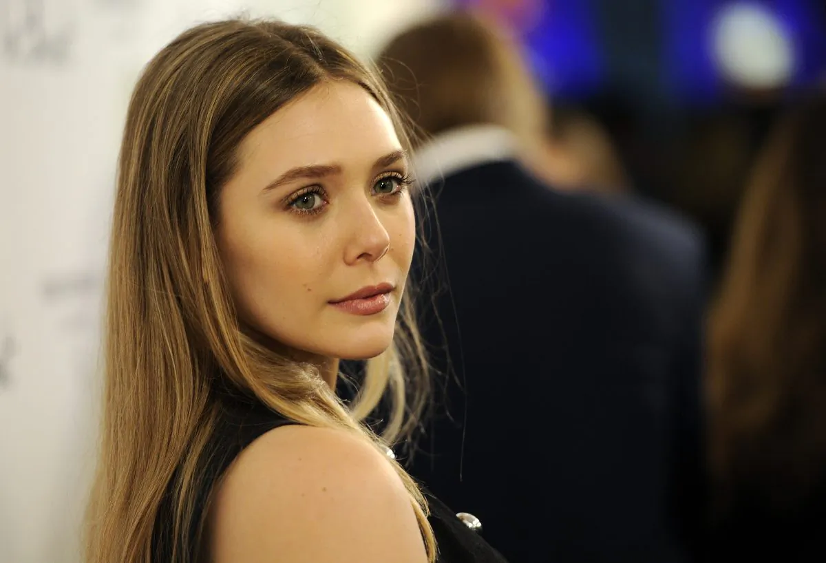 Elizabeth Olsen, a cast member in "In Secret," poses at the premiere of the film on Thursday, Feb. 6, 2014, in Los Angeles. (Photo by Chris Pizzello/Invision/AP)