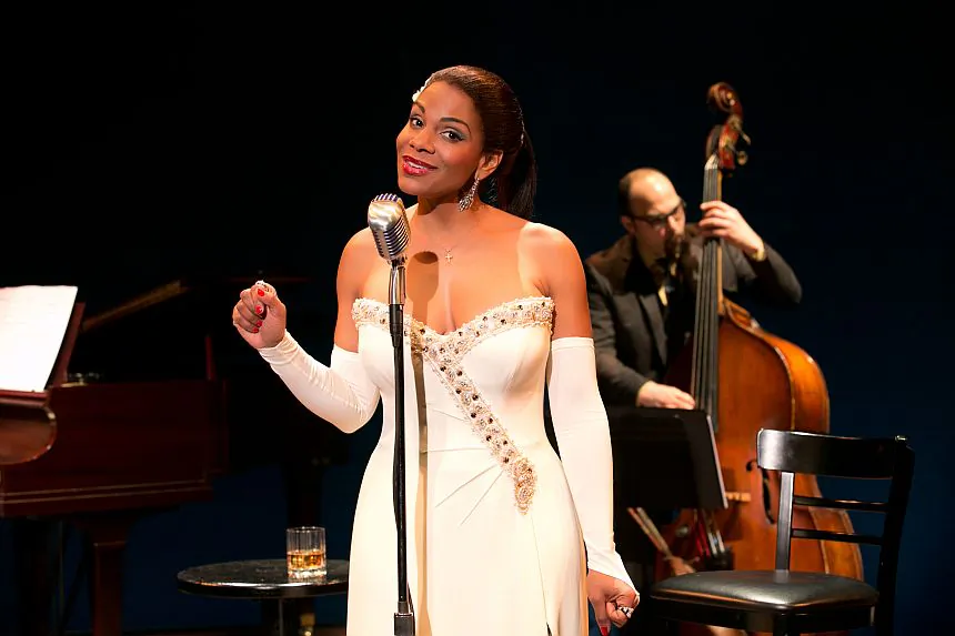 illie Holiday (Audra McDonald) with a member of the band, George Farmer on bass, behind her. (Evgenia Eliseeva)