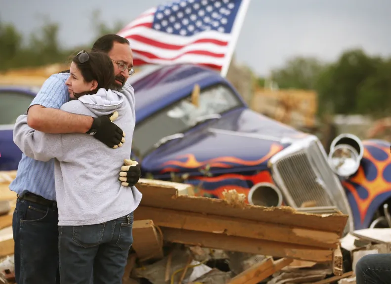 Dan Wassman gets a hug from friend Amy Lundsford at the homesite of his son who was killed when a tornado destroyed the home late Sunday afternoon, April 29, 2014 in Vilonia, Ark.  (Mark Wilson/Getty Images)