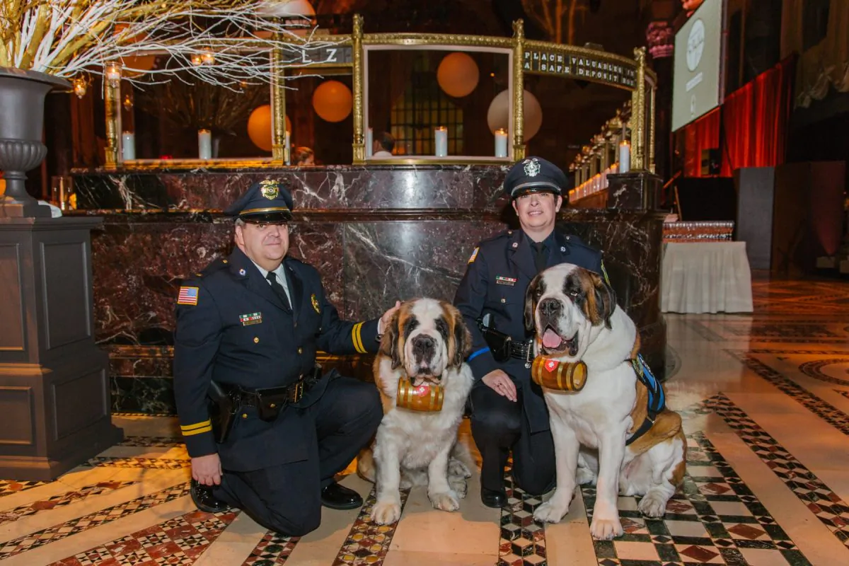 Lt. William Gordon (L) and Officer Laura Gordon (R) with their Saint Bernards Rosie and Clarence, at the Animal Medical Center Top Dog Award Gala, Dec. 2013. (Photo courtesy of Lt. William Gordon)