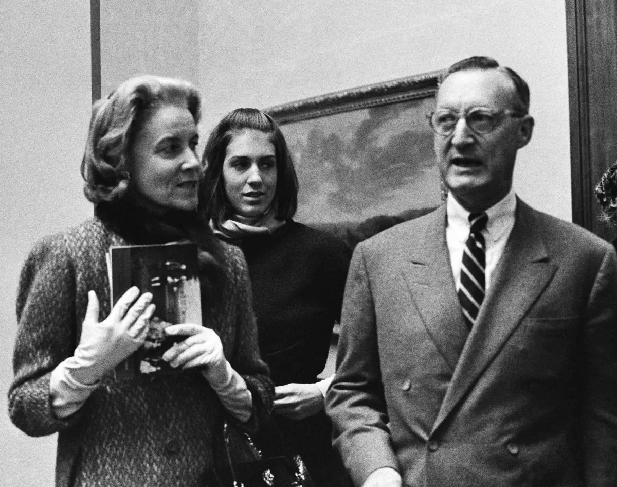 In this Dec. 11, 1964, file photo, Paul Mellon, of Virginia, his wife, Bunny Mellon, left, and stepdaughter Eliza Lloyd appear at a preview of the Mellon's collection of English Art at the Royal Academy in London. Rachel "Bunny" Mellon, a wealthy arts and fashion patron, friend of first lady Jacqueline Kennedy and political benefactor died on March 17, 2014. (AP Photo/File)
