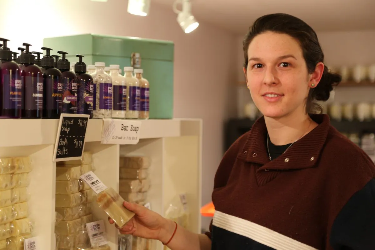 Carly Pereira, sales manager at Purple Urchin, shows one of the 33 bar soaps available at the store. (Pam McLennan/Epoch Times)