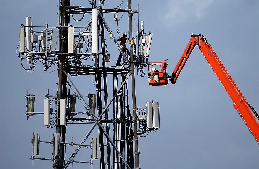 A worker climbs on a cellular communication tower in Oakland, California on March 6. (Justin Sullivan/Getty Images)