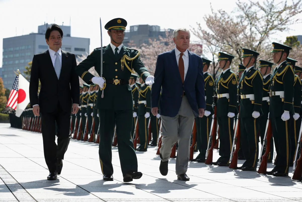 Accompanied by Japanese Defense Minister Itsunori Onodera (L), U.S. Secretary of Defense Chuck Hagel (R) reviews honor guards at the Japanese Ministry of Defense headquarters April 6 in Tokyo. The United States will provide two additional missile defense ships to Japan. (Alex Wong/Getty Images)