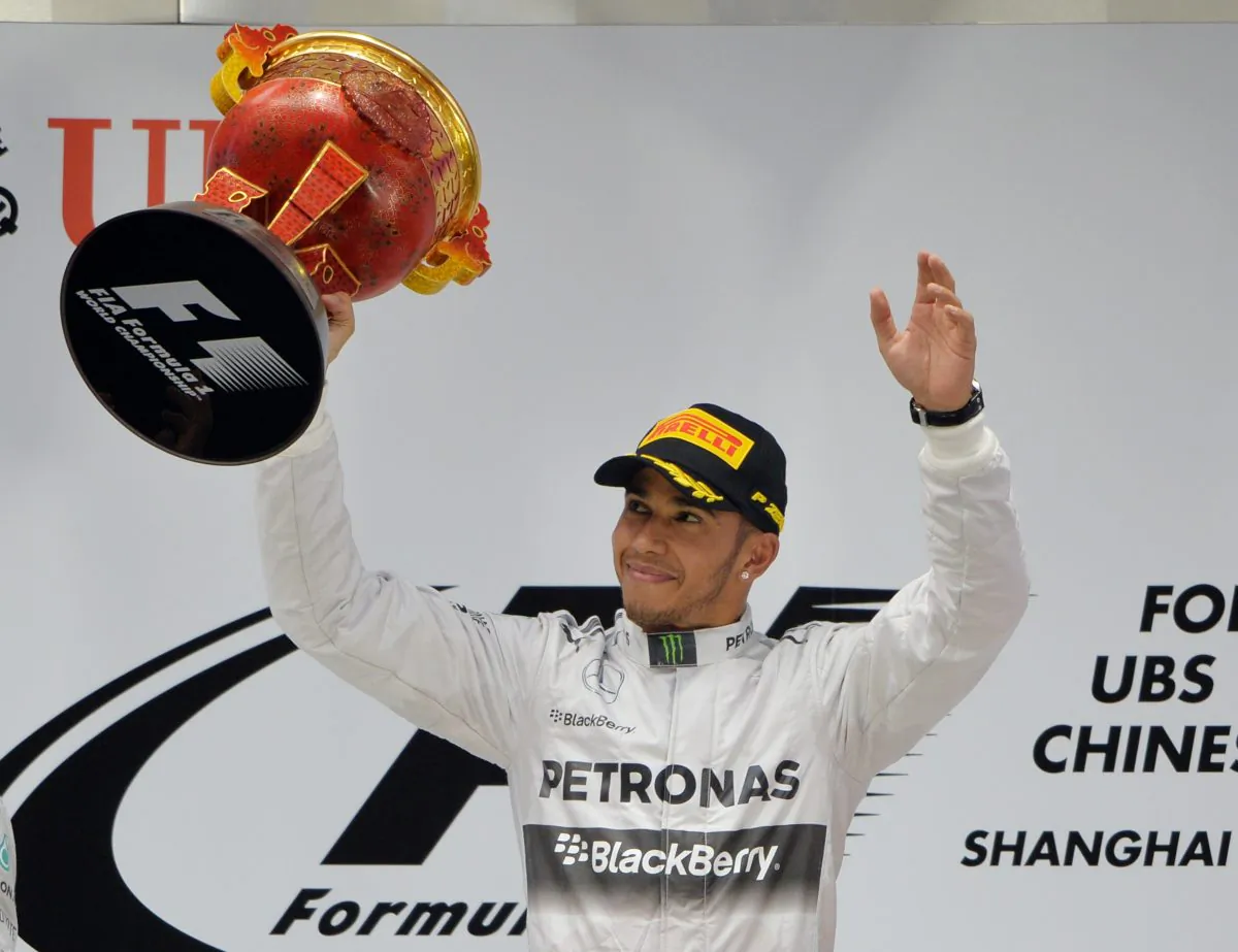 Mercedes AMG Petronas driver Lewis Hamilton celebrates on the podium after winning the Formula One Chinese Grand Prix in Shanghai on April 20, 2014. (Mark Ralston/AFP/Getty Images)
