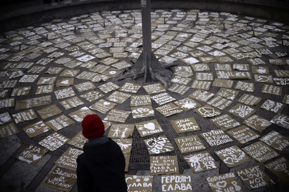 A boy looks at messages of peace arranged on Independence Square, or Maidan Square, in central Kiev on March 9, 2014. (Dimitar Dilkoff/AFP/Getty Images)