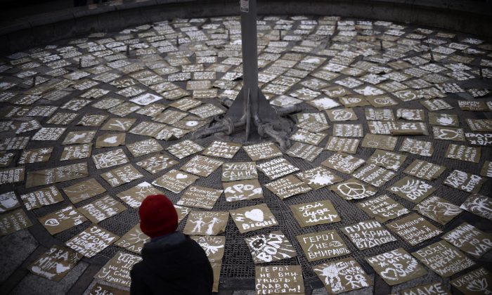 A boy looks at messages of peace arranged on Independence Square, or Maidan Square, in central Kiev on March 9, 2014. (Dimitar Dilkoff/AFP/Getty Images) 
