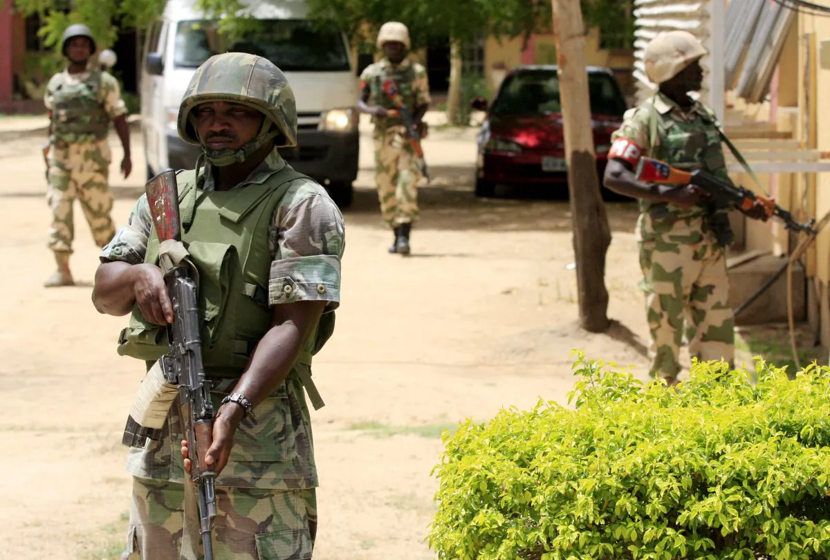 Nigerian soldiers stand guard at the offices of the state-run Nigerian Television Authority in Maiduguri, Nigeria, in this file photo taken June 6, 2013. (Jon Gambrell, File/AP Photo)