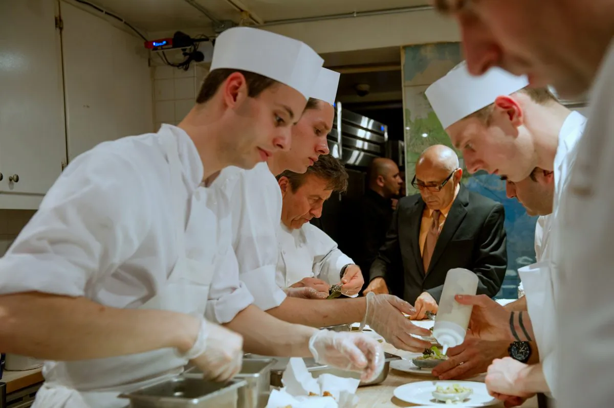 James Beard Award-winning chef Daniel Boulud and his team plating for service during the “Dinner with Daniel” event held at the James Beard House on Monday, March 31, 2014. (Courtesy of Ken Goodman)