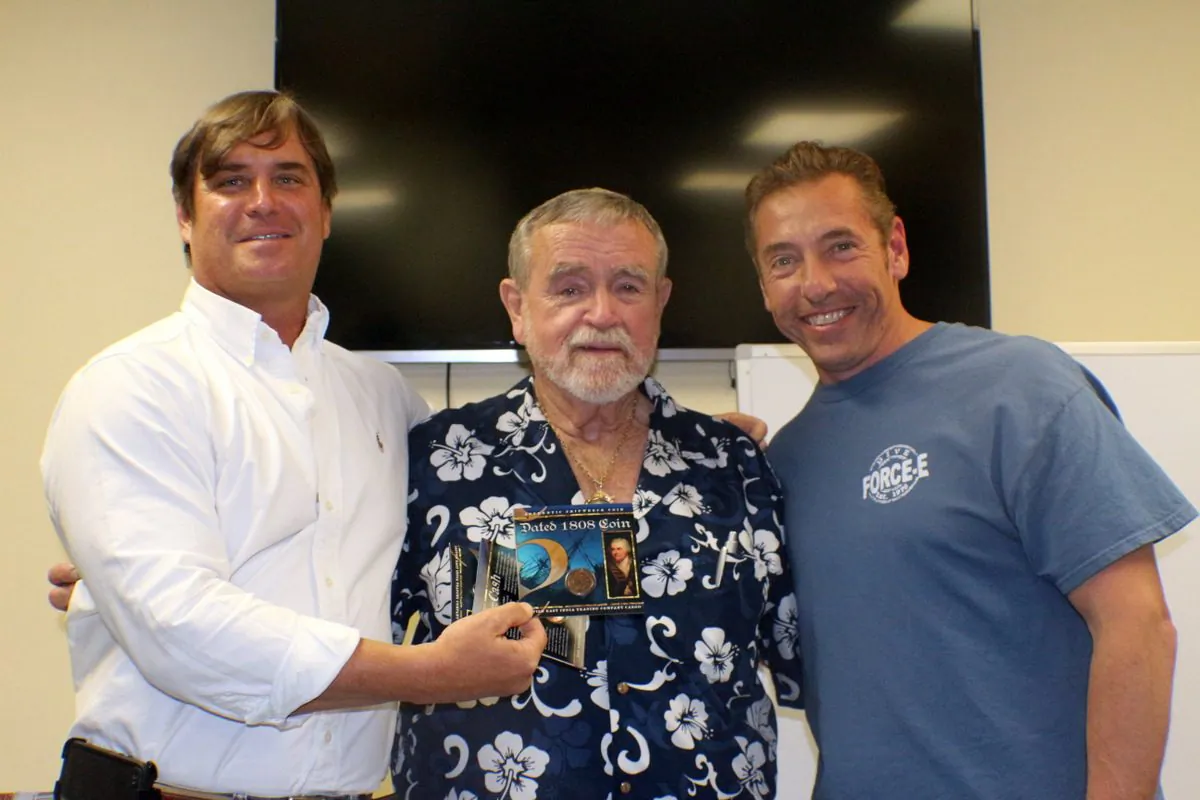 Captain Brad Williamson, Carl Fismer and winner of a shipwreck coin drawn from free raffle tickets at Force-E. Free prizes and drawings offer incentives for divers to attend lectures and programs. (Myriam Moran copyright 2014)