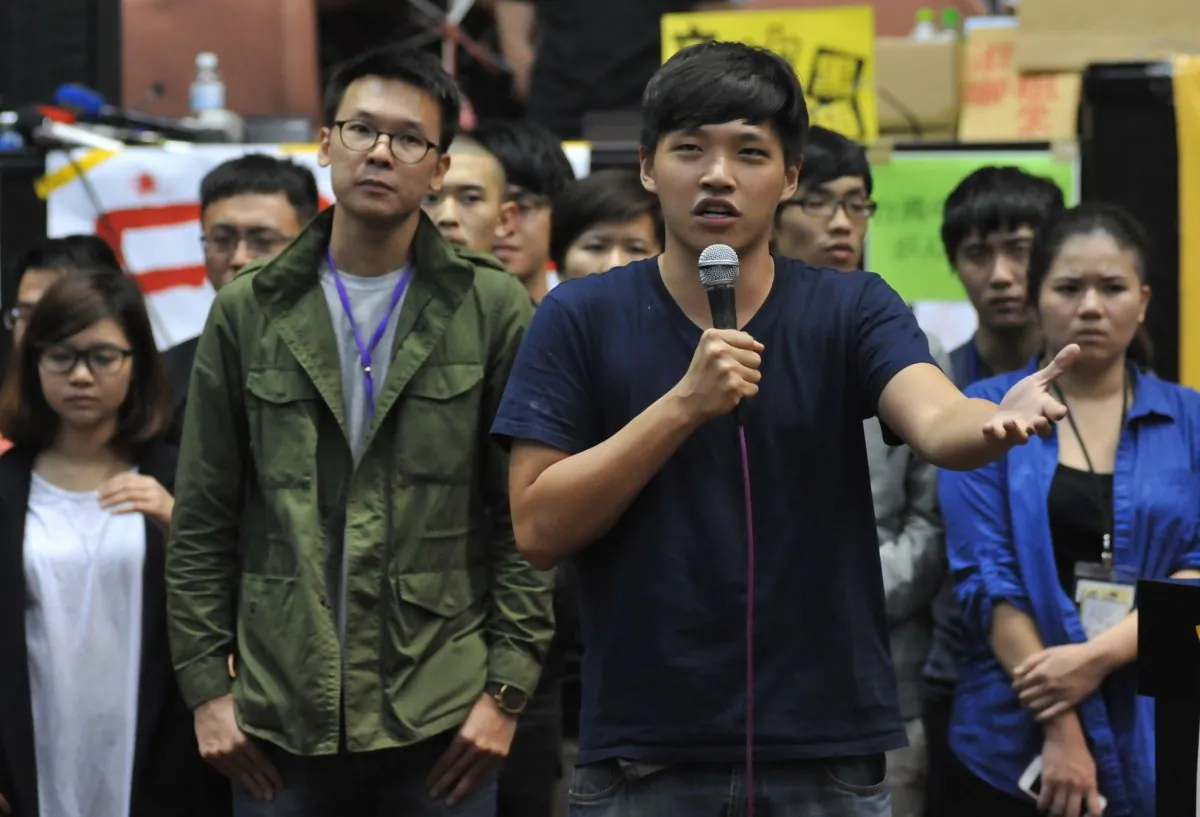 Student protest leader Chen Wei-ting (R) speaks during a protest against a contentious trade agreement with China inside the Legislative Yuan in Taipei on April 7, 2014. Taiwanese protesters said they would leave on April 10. (Mandy Cheng/AFP/Getty Images)