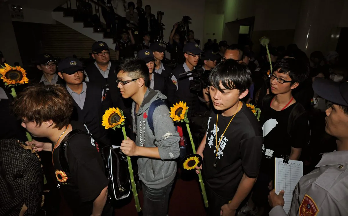 Students protesters walk out from the parliament building after they ended an occupy protest over a contentious trade pact with China, in Taipei on April 10. (SAM YEH/AFP/Getty Images)