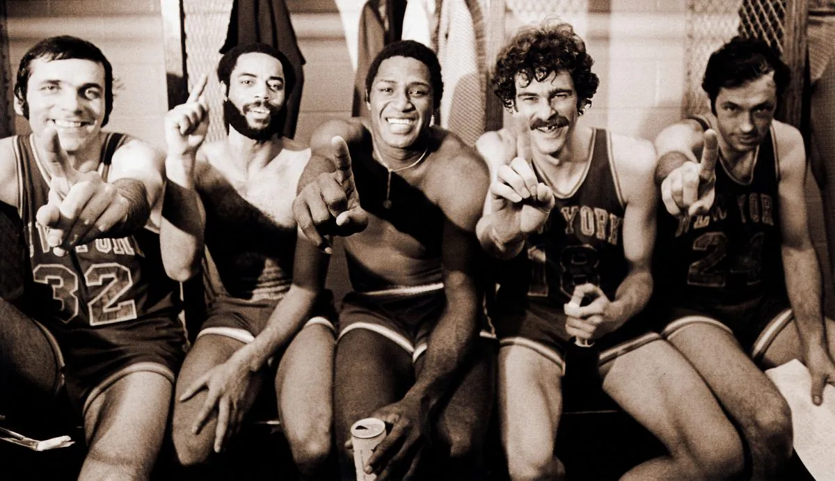(L–R) Jerry Lucas, Walt Frazier, Willis Reed, Phil Jackson, and Bill Bradley celebrate after winning the 1973 NBA Title in five games against the Los Angeles Lakers. (George Kalinsky)
