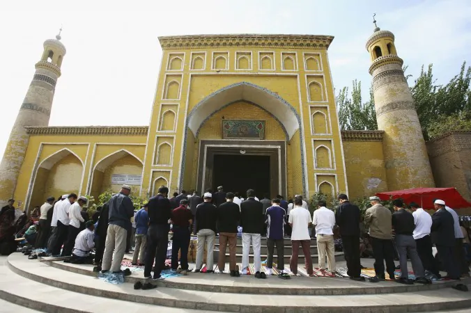 Muslims pray outside a mosque on Sept. 22, 2006 in Kashi of Xinjiang Uygur Autonomous Region, northwest China. The governor of the traditionally Muslim province of Xinjiang has recently warned that Islamists seek a ban on laughter at marriages and tears at funerals, and blamed them for terrorist activities. (China Photos/Getty Images)