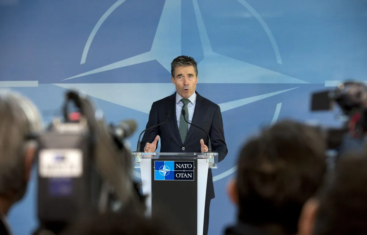Then-NATO Secretary General Anders Fogh Rasmussen gestures while speaking during a media conference ahead of a meeting of the North Atlantic Council at NATO headquarters in Brussels on April 1, 2014. (Virginia Mayo/AP Photo)