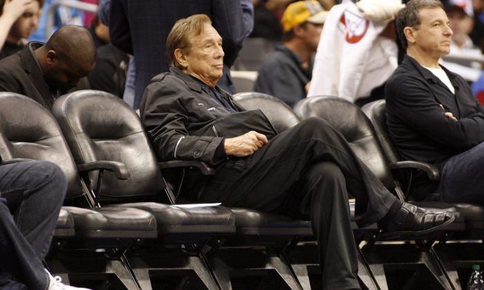 FILE - In this April 4, 2010, file photo, Los Angeles Clippers owner Donald Sterling sits courtside during the NBA basketball game between the New York Knicks and the in Los Angeles. NBA Commissioner Adam Silver Silver announced Tuesday, April 298, 2014, that Sterling has been banned for life by the league, in response to racist comments the league says he made in a recorded conversation.(AP Photo/Danny Moloshok, File)