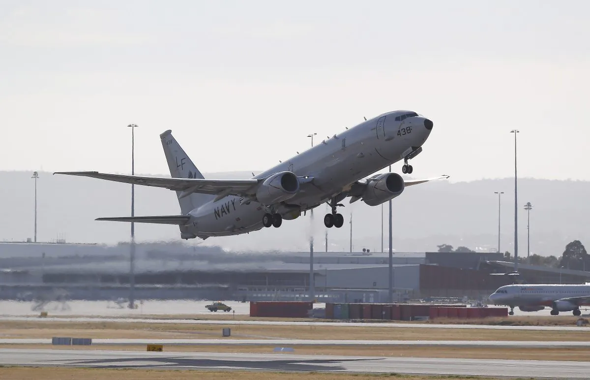 A U.S Navy P-8 Poseidon takes off from Perth International Airport on the way to rejoin the ongoing search operations for missing Malaysia Airlines Flight 370 in Perth, Australia, April 17, 2014. (AP Photo/Theron Kirkman, Pool)